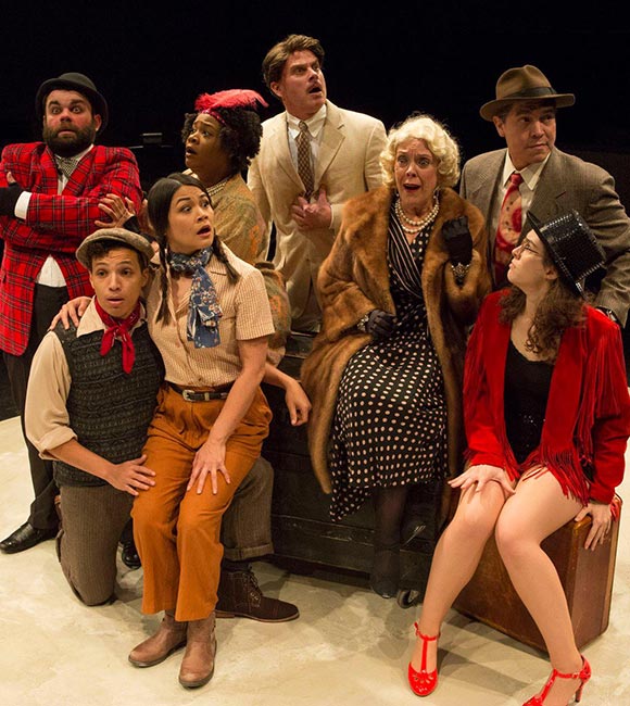 group of actors on stage look surprised
